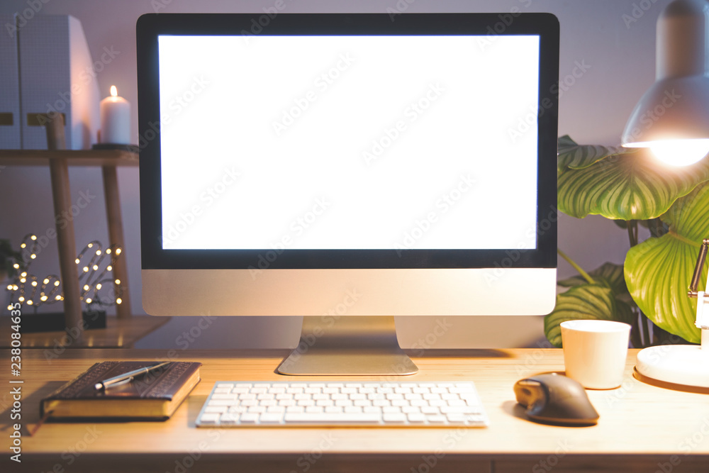 Stylish scandinavian interior of home creative desk by night with mock up computer screen, plants, office accessories and notes. Minimalistic space for work, hobby and listen music. Freelancer space. Stylish scandinavian interior of home creative desk by night with mock up computer screen, plants, office accessories and notes. Minimalistic space for work, hobby and listen music. Freelancer space.