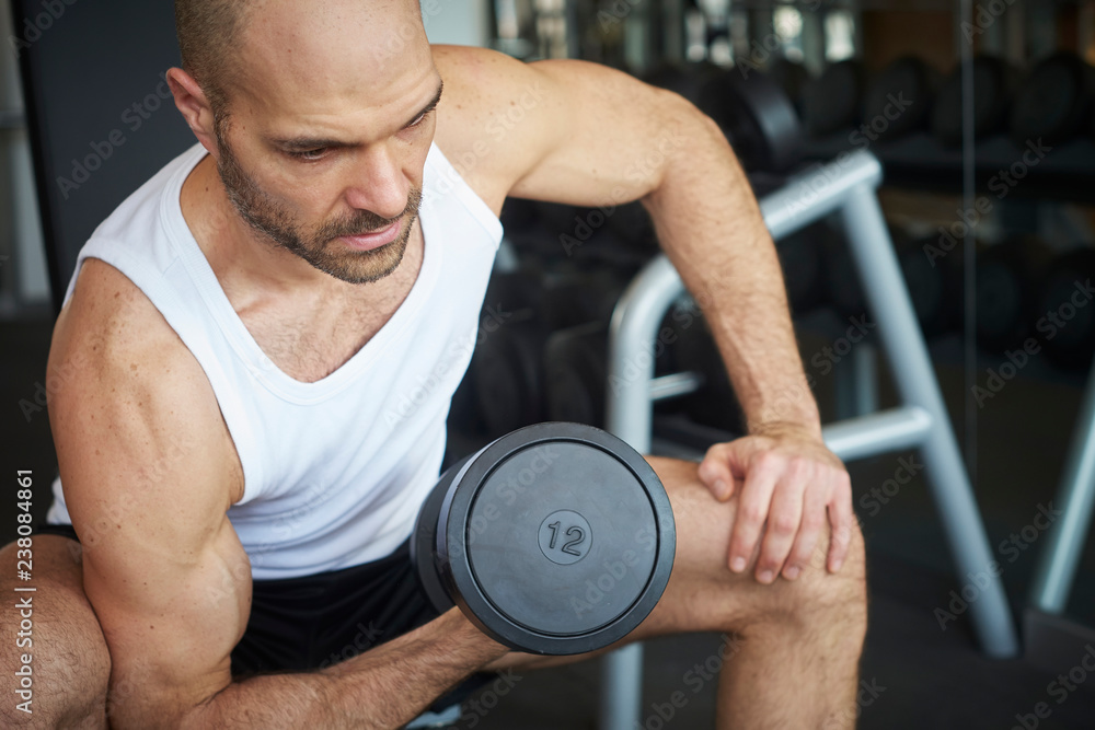 Man training with dumbbell workout in the gym Man training with dumbbell workout in the gym