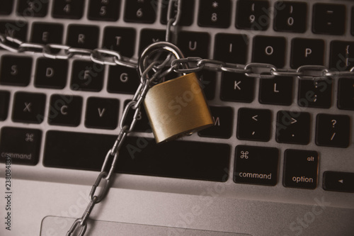 Cyber safety concept, locked chain on laptop computer keyboard