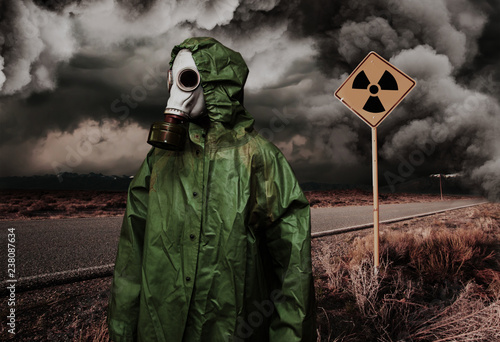 Wallpaper Mural Man in gas mask with radiation area caution sing. Nature protection concept Torontodigital.ca