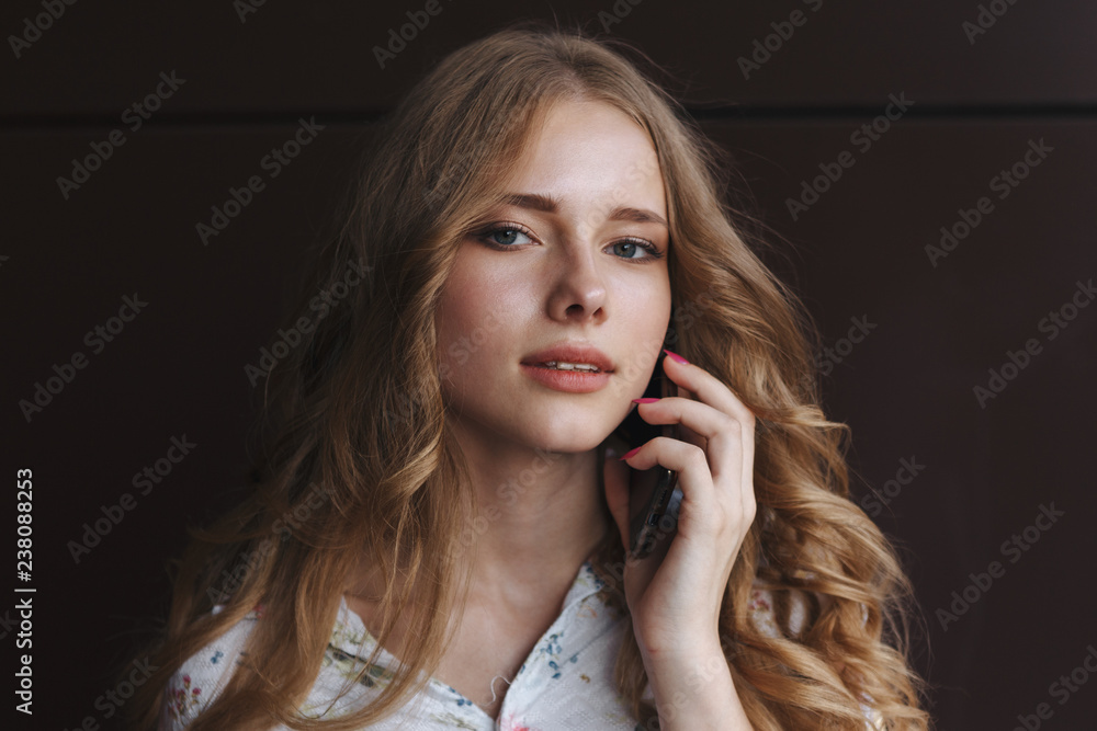 Young charming woman calling with cell phone,, attractive woman with cute smile talking with mobile phone while relaxing.closeup. business woman with Young charming woman calling with cell phone,, attractive woman with cute smile talking with mobile phone while relaxing.closeup. business woman with
