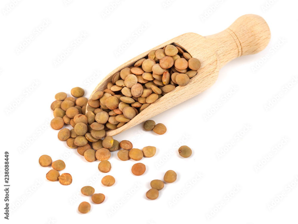 dry lentils on wooden spoon isolated on a white background dry lentils on wooden spoon isolated on a white background