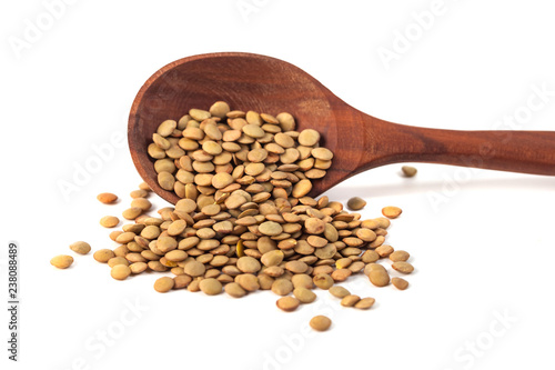dry lentils on wooden spoon isolated on a white background