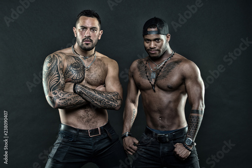 Tattoo brutal attribute. Men brutal attractive hispanic appearance tattooed body. Bearded men show tattooed torso. Brutal strict macho with tattoos. Masculinity and brutality. Tattoo culture concept