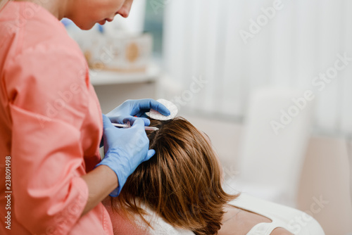 Фотография Woman getting mesotherapy injection in head for strengthen hair