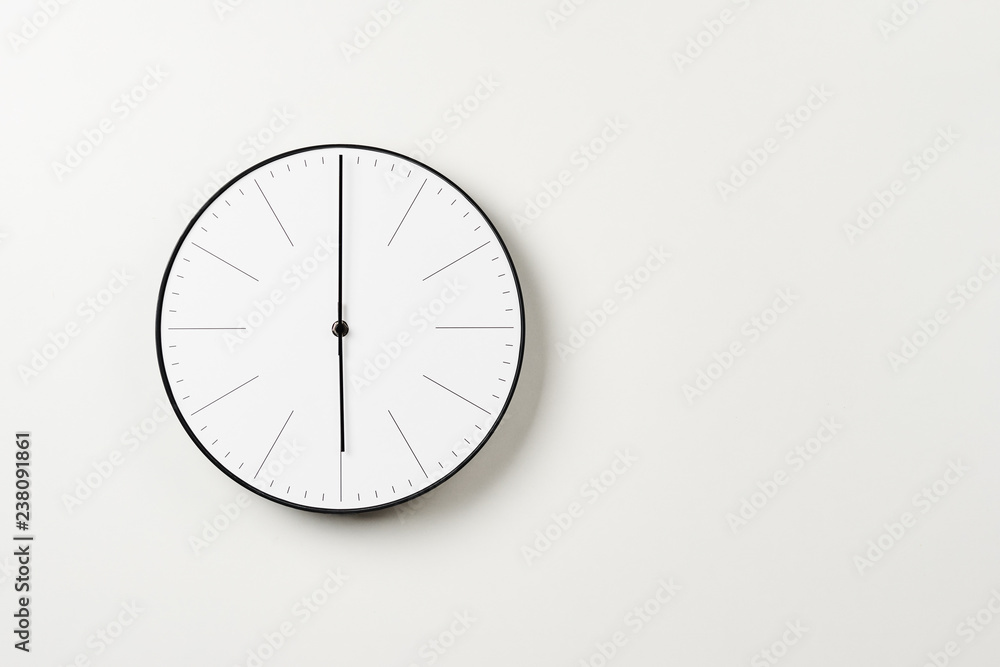 Classic round wall clock on a white background with copy space Classic round wall clock on a white background with copy space