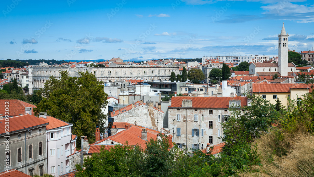 Panoramic view of Pula with ancient Roman Amphitheater and church tower, Istria region, Croatia