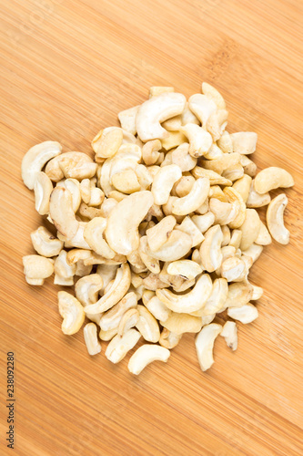 Pile of raw unroasted cashew halves and pieces