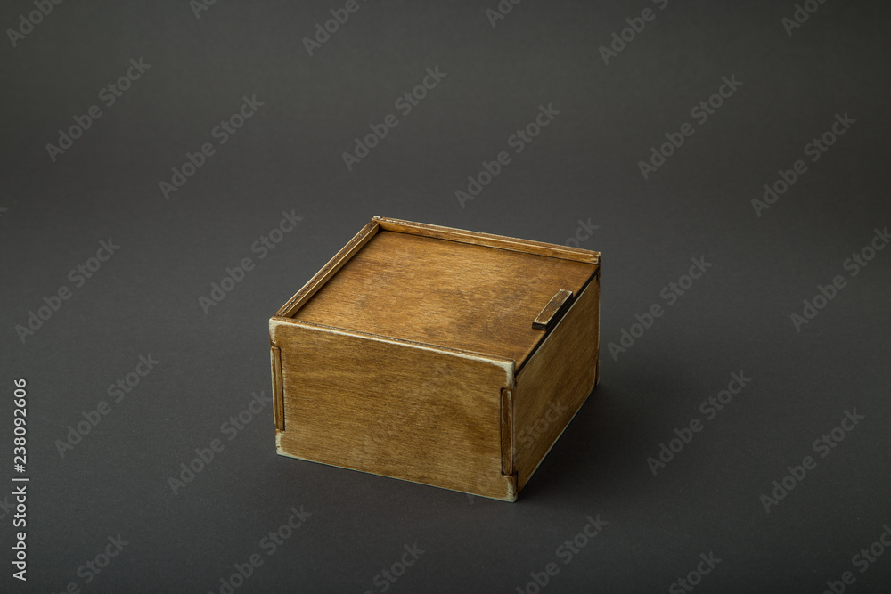 Wooden box, gift wrap, on a dark background Wooden box, gift wrap, on a dark background