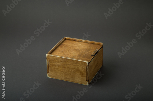 Wooden box, gift wrap, on a dark background