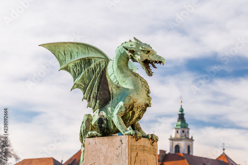 The Ljubljana dragon with the cathedral of St. Nicolas on background  Ljubljana  Slovenia.