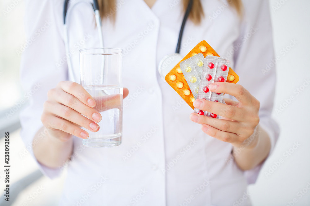 Doctor holding pills on hand. Medicine and health care concept Doctor holding pills on hand. Medicine and health care concept
