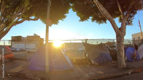 Moving shot of sidewalk homeless tent camps in the gritty skid row area of downtown Los Angeles. photo