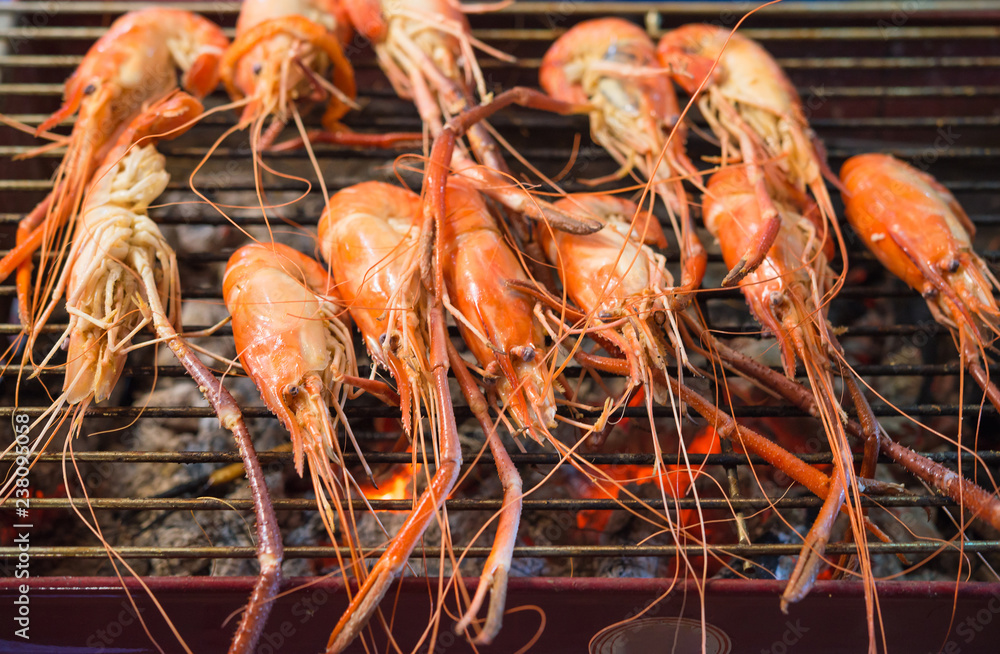 shrimp grilled bbq seafood on charcoal stove for sale at Thai street food market shrimp grilled bbq seafood on charcoal stove for sale at Thai street food market