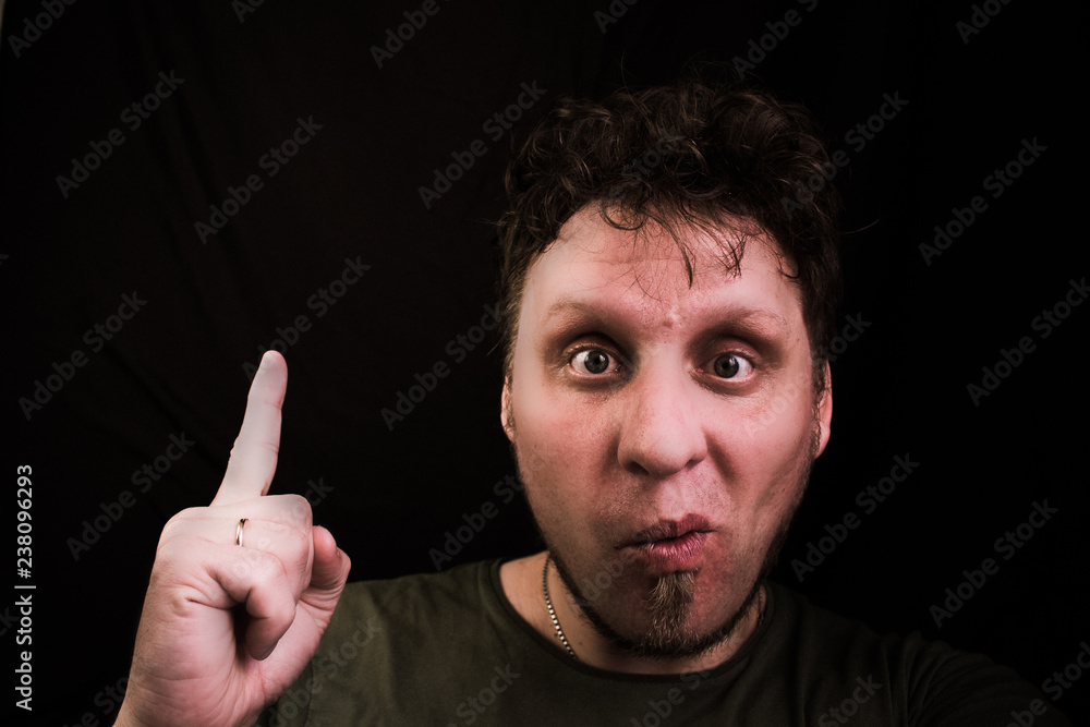 The man is holding his index finger up. Idea. Bingo. The man is holding his index finger up. Idea. Bingo.