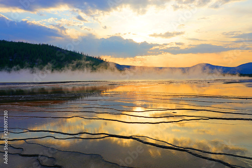 Fiery orange sunset over the Grand Prismatic pool in Yellowstone National Park  United States