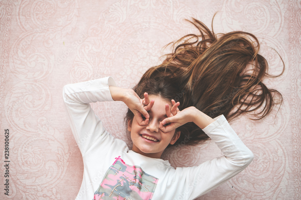 Fototapeta premium Portrait of a happy laughing child girl