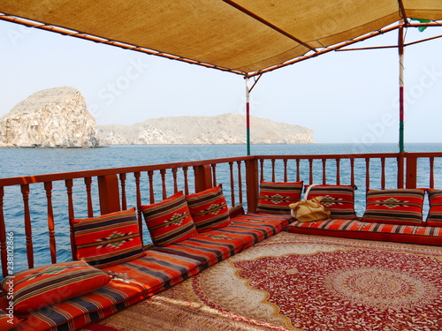 view onside a traditional dhow boat with pillows and carpet cruising the magnificant fjords of Khasab, Musandam, Oman, Middle East photo