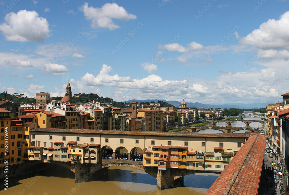Florence Italy view on old bridge Ponte Vecchio at Arno river. Beautiful cloudy sky.