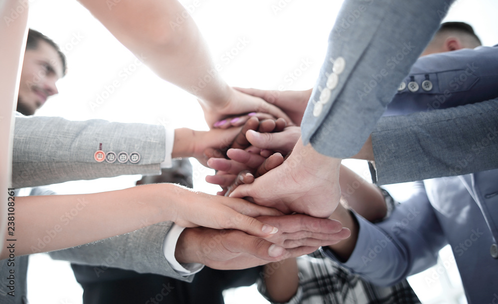 Closeup of a business colleagues with their hands stacked together Closeup of a business colleagues with their hands stacked together