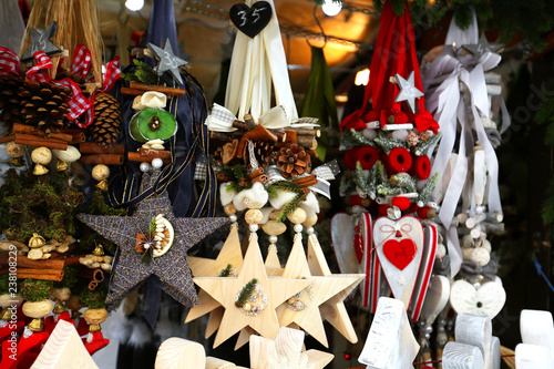 Wooden multi-colored Christmas toys for decorating house at Christmas Market. Wroclaw xmas market in Europe on holidays. 