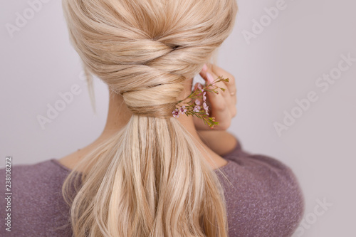 Portrait of an elegant young woman with blond hair. Trendy hairstyle