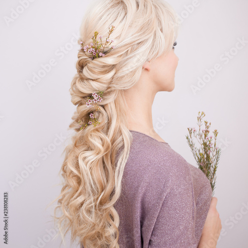 Portrait of an elegant young woman with blond hair. Trendy hairstyle