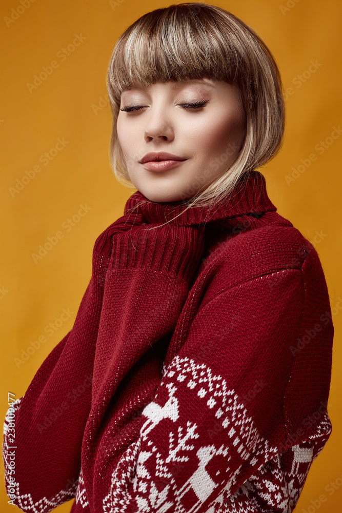 Beautiful blond woman with short hair in christmas sweater Beautiful blond woman with short hair in christmas sweater