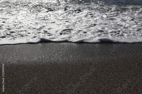 Fototapeta Naklejka Na Ścianę i Meble -  Sand beach with wave foam. Sea beauty background.