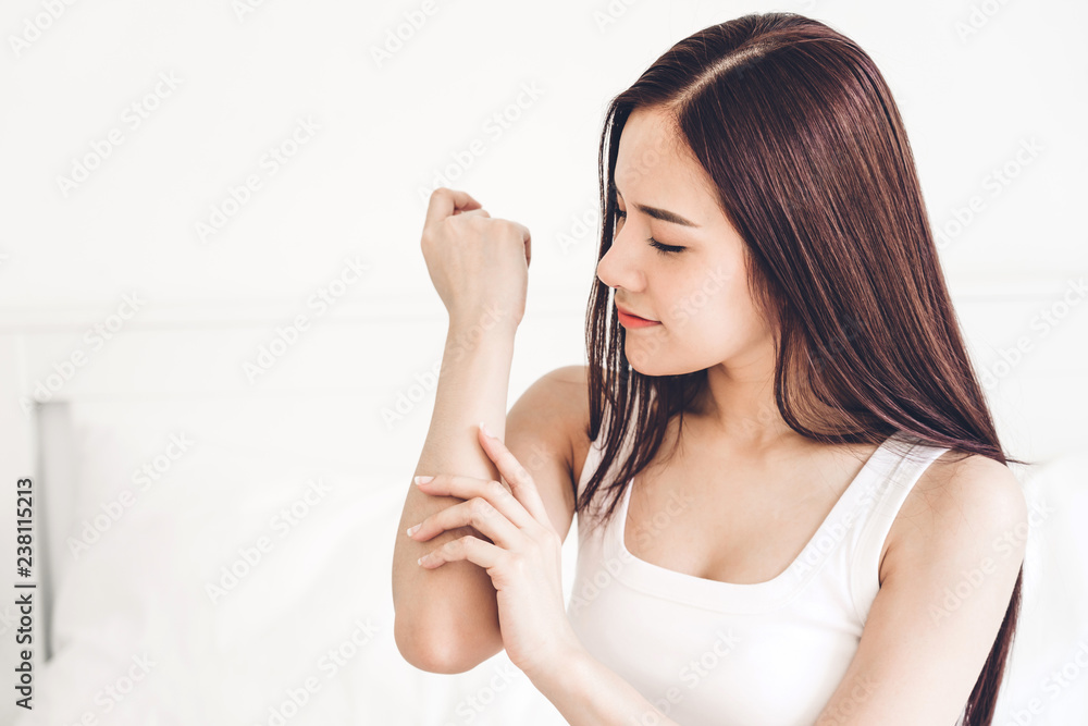 Beautiful woman beauty health care.beauty and spa.perfect fresh skin.woman touch her arm on the bed at home Beautiful woman beauty health care.beauty and spa.perfect fresh skin.woman touch her arm on the bed at home