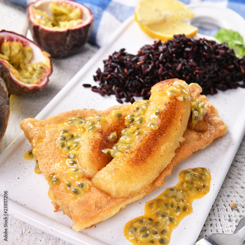 Traditional madeira dish - scabbardfish with bananas and passion fruit photo