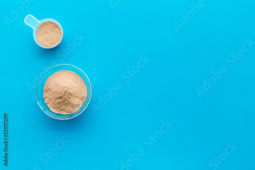 protein cocktail with powder for sport nutrition set l on blue background top view mock-up