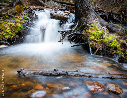 Long exposure of waterfall in mountain stream with moss