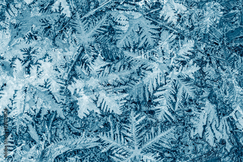 beautiful festive frosty pattern with snowflakes on blue background
