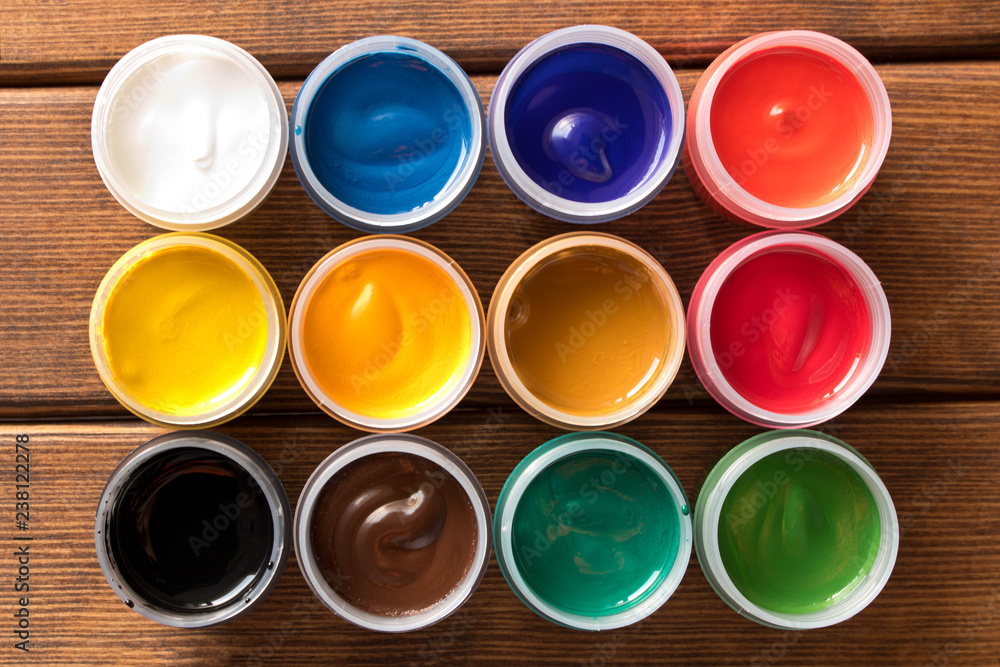 Various paints on the old wooden table . Creative concept. Top view Various paints on the old wooden table . Creative concept. Top view