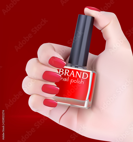 Woman s hand holding bottle of red nail polish.