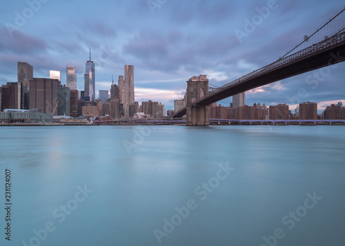 View on Brooklyn Bridge and financial district from east river at sunrise with long exposure © Andriy Stefanyshyn