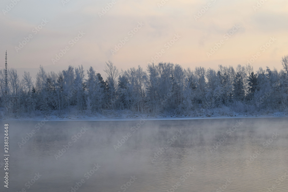 Winter landscape. The ice on the river. The mist over the water. Low air temperature. Winter landscape. The ice on the river. The mist over the water. Low air temperature.