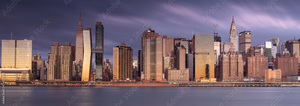 Panorama view on Midtown Manhattan from east river at sunrise with long exposure