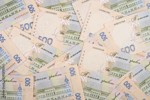 A close-up of a pattern of many Ukrainian currency banknotes with a par value of 500 hryvnia.