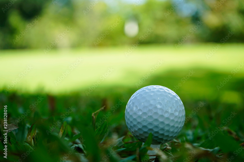 Golf ball on tee in beautiful golf course at sunset background. Golf ball on tee in beautiful golf course at sunset background.