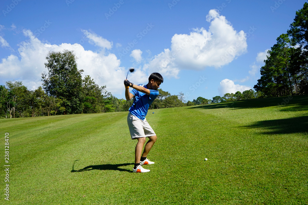 Fototapeta premium Golfer playing golf in beautiful golf course in the evening golf course with sunshine in thailand