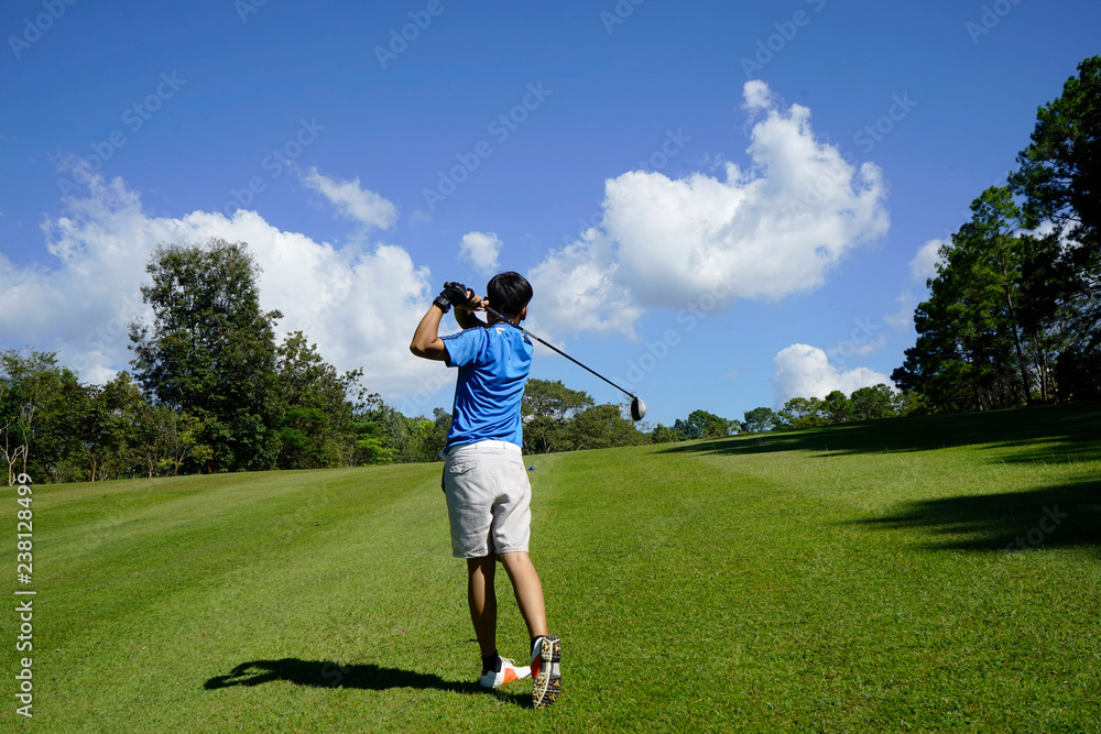 Golfer playing golf in beautiful golf course in the evening golf course with sunshine in thailand Golfer playing golf in beautiful golf course in the evening golf course with sunshine in thailand