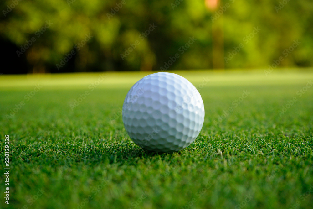 Golf ball on green in beautiful golf course at sunset background. Golf ball on green in golf course at Thailand Golf ball on green in beautiful golf course at sunset background. Golf ball on green in golf course at Thailand