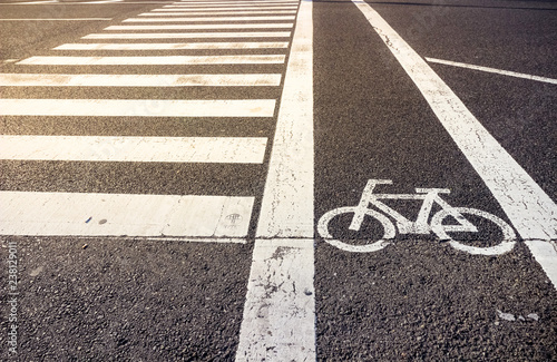 Bike lane symbol with crosswalk on asphalt street
