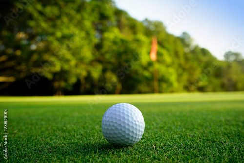 Golf ball on green in beautiful golf course at sunset background. Golf ball on green in golf course at Thailand photo