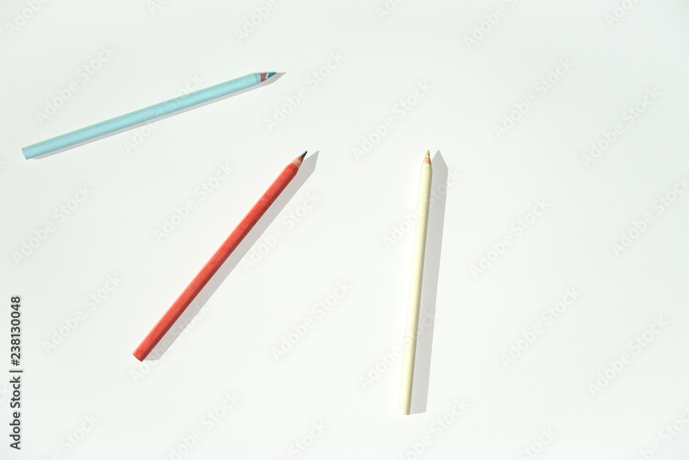 Blue, yellow and red color pencil on white paper Blue, yellow and red color pencil on white paper