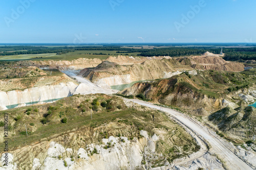 Fototapeta Naklejka Na Ścianę i Meble -  An old gypsum quarry filled with blue and pure water. Aerial view, from top to bottom