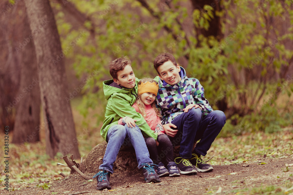 Portrait of Two cheerful happy boys and girl in autumn Portrait of Two cheerful happy boys and girl in autumn