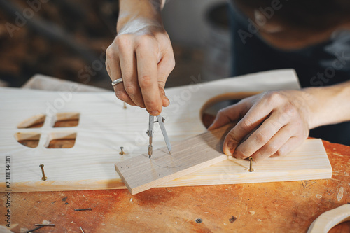 The carpenter works with a tree